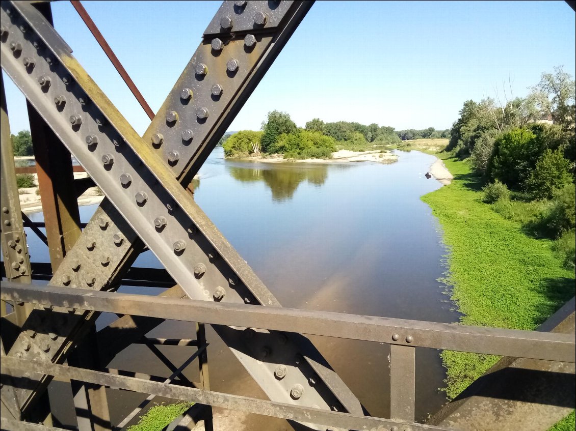 L'embarcation attend en aval du joli pont façon Eiffel.