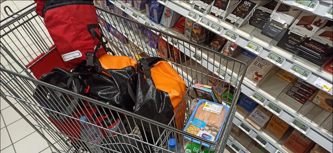 Quand il n'y a pas de supérettes - épiceries mais un supermarché, je mets les sacoches dans le caddie pour éviter les vols. Sans commentaire sur le rayon de chocolat 🙂